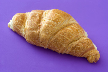 Croissant on violet background. Top view

