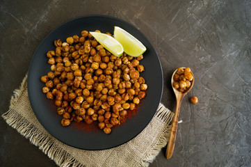 Roasted spicy chickpeas on a rustic background.