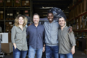 Portrait of four people in warehouse