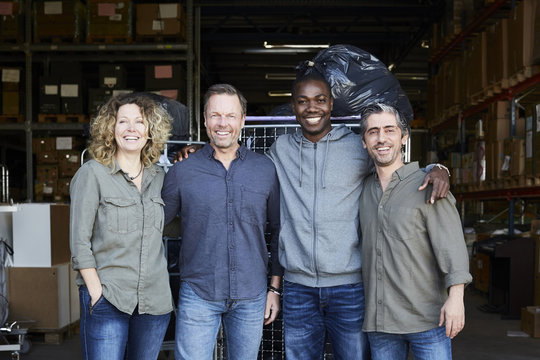 Portrait of four people in warehouse