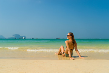 Fototapeta na wymiar woman resting at the tropical Thailand Railay beach in Thailand