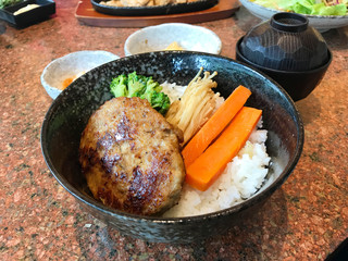 Japanese cuisine, rice topped with hamburg steak or Hambagu, made from ground beef or pork, carrot, broccoli and mushroom