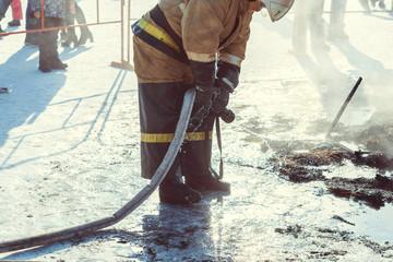 firefighter extinguishes with water