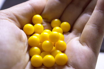 A lot of yellow balls in the palm of your hand