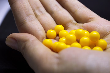 A lot of yellow balls in the palm of your hand