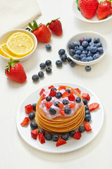 Pancakes with fruit yogurt, fresh strawberry and blueberry