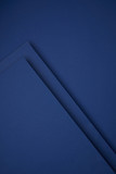 dark abstract background made from blue colored paper