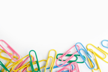 A lot of colorful paper clips on white background.
