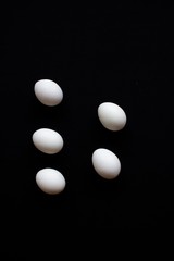 White eggs on black background 