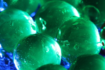 Close up transparency colorful jelly balls on glass dish on black background