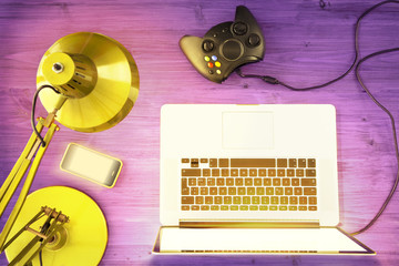 overhead of a teen's desk / aerial view of a game station in a colored desk