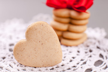cookies in the shape of heart on a gray background, minimalism, concept of cooking, baking, symbol of love