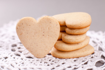 cookies in the shape of heart on a gray background, minimalism, concept of cooking, baking, symbol of love