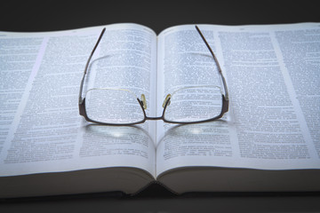 Eyeglasses on an opened text book