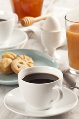 Coffee cup and breakfast table.