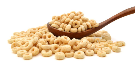 healthy cereal rings and wooden spoon on white