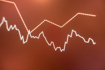 Stock exchange market graph analysis in red background