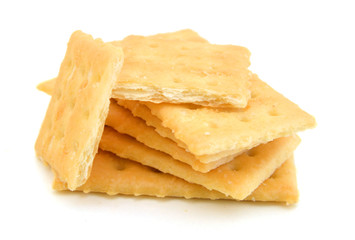 Salty crackers in square shape on white background