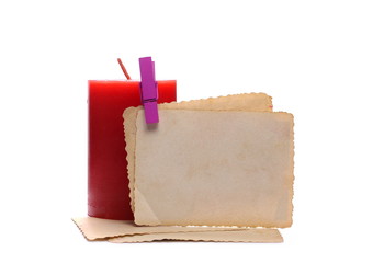 Old photo frame and red candle isolated on white background