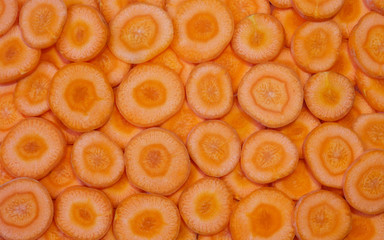 Orange round fresh cut carrot peels background