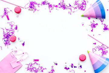 Birthday party accessories. Party hat, sweets, confetti on white background top view copy space