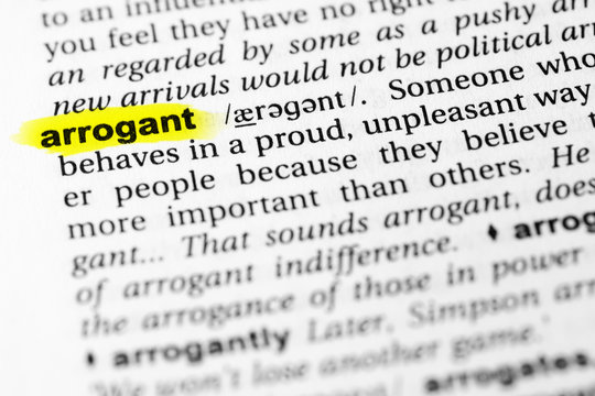 Highlighted English word "arrogant" and its definition in the dictionary