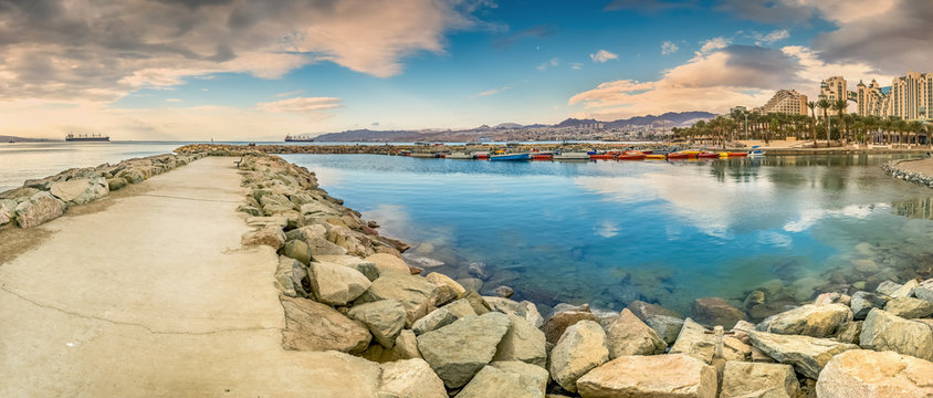 Panoramic view on stone walking pier and marine lagoon from central walking promenade in Eilat - famous resort city in Israel