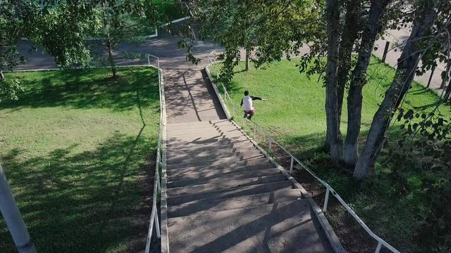 Aggressive inline roller blader grind on rail in skatepark outside. Clip. Summer extreme sport exercising outdoor in skate park. Skater guy grinding on railing in park. Cool activity hobby for young