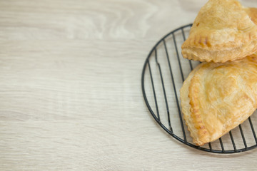 PASTRY ON GRILL
Puff pastry on black grill on wood table.