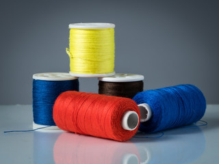 Spools of various colored threads for knitting