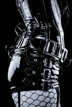 woman in black latex uniform with metal buckles