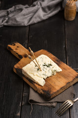 Portion of cheese roquefort at a table rustic.