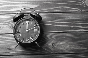retro alarm clock on woodwn background