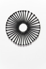 Wonderful circle of black screws, set one by one, isolated on a white background