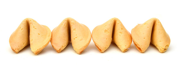 Many Chinese fortune cookies stacked up, on white background
