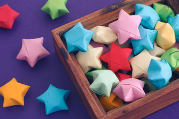Colourful origami lucky stars in a wooden box