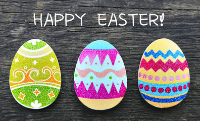 Happy Easter card.Colorful handmade  easter eggs on old wooden background.
Selective focus.