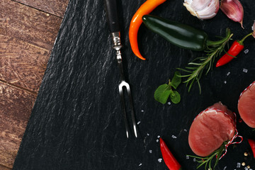 Raw beef fillet steaks mignon on dark background