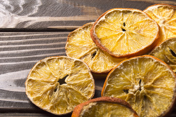 Dried orange and lemon slices on wooden background. rings of dried citrus on table.