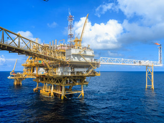 Fototapeta premium Offshore oil and Gas central processing platform and remote platform produced oil, natural gas and liquid condensate for set to onshore refinery from offshore in ocean sea background.