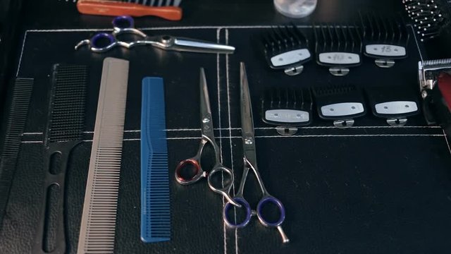 Close-up panorama shot of hairdresser tools. Scissors and combs.