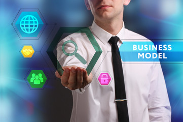 Business, Technology, Internet and network concept. Young businessman working on a virtual screen of the future and sees the inscription: Business model