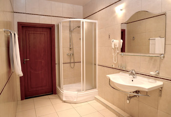 Bathroom with a shower booth and a sink in beige tones