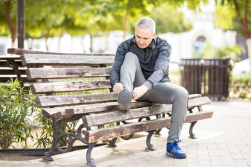 Fototapeta premium Fit and healthy man getting ready to go jogging in park
