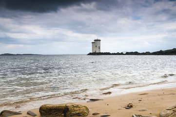 Carriag Fhada / The two square towers of the Carriag Fhada Lighthouse at Port Ellen on the Scottish...
