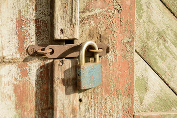 rusty lock on old wooden door