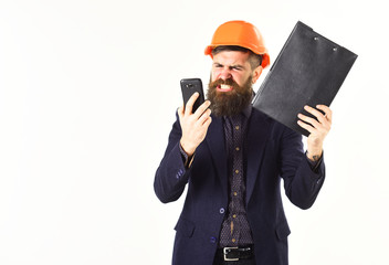 Supervisor with papers and angry face holds smartphone.