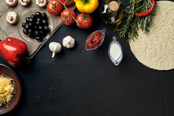 Pizza cooking ingredients. Dough, vegetables and spices. Top view with copy space