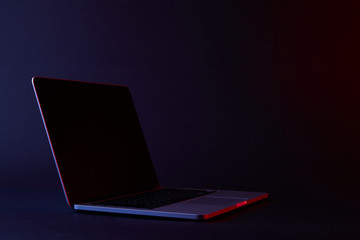 one turned off laptop with reflecting screen on dark - Powered by Adobe