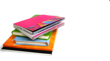 pile of books and notebooks on the white isolated background